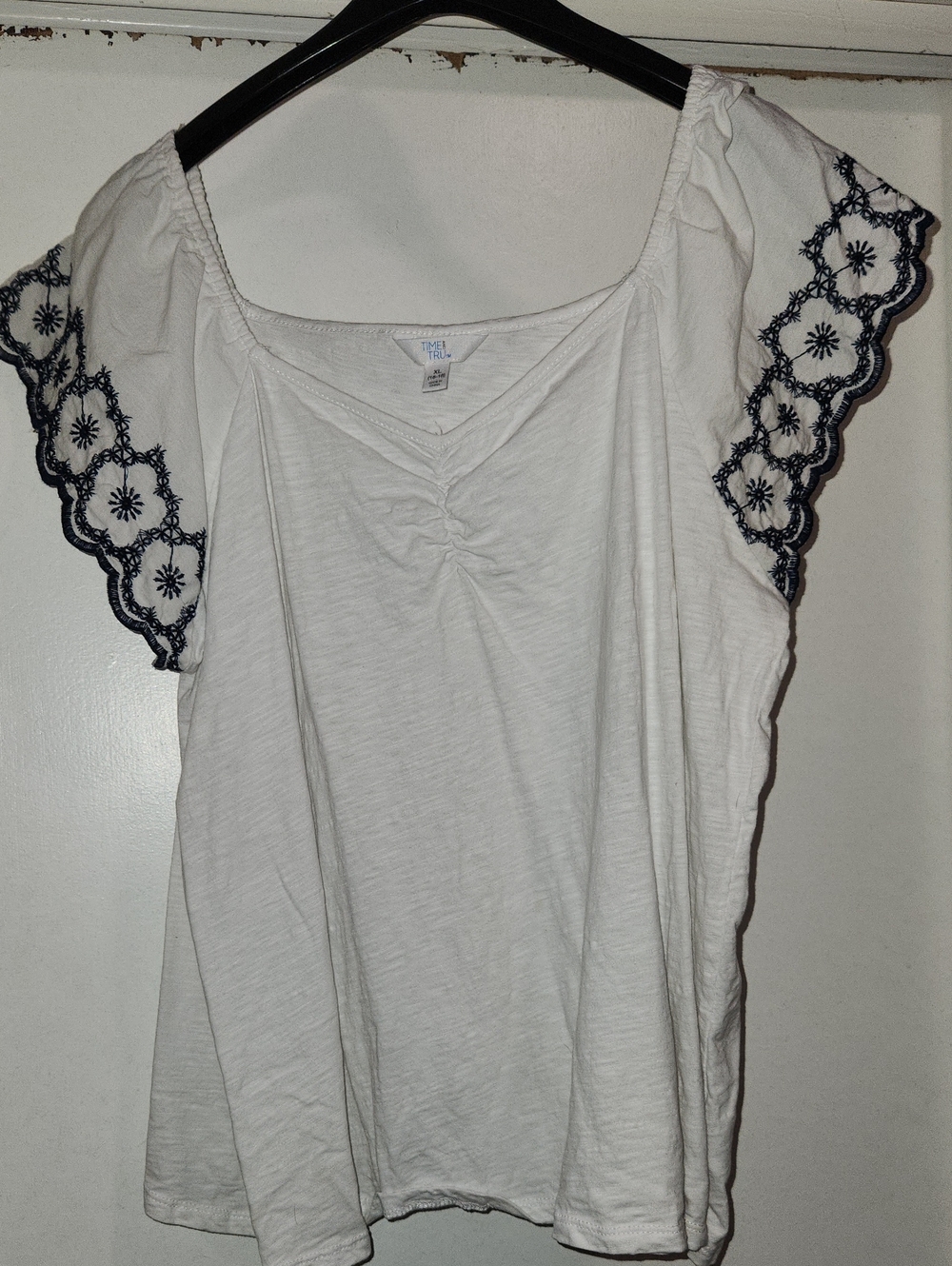 White Top with Navy Eyelet Flutter Sleeves